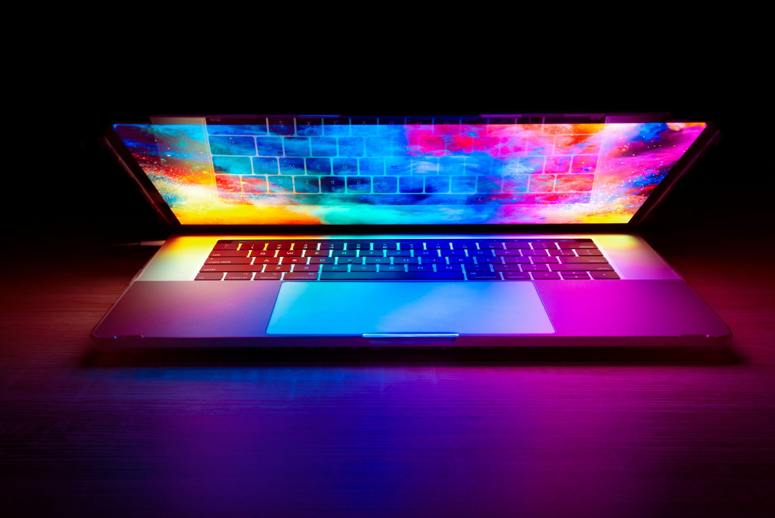 neon open laptop photo by josjua woroniecki